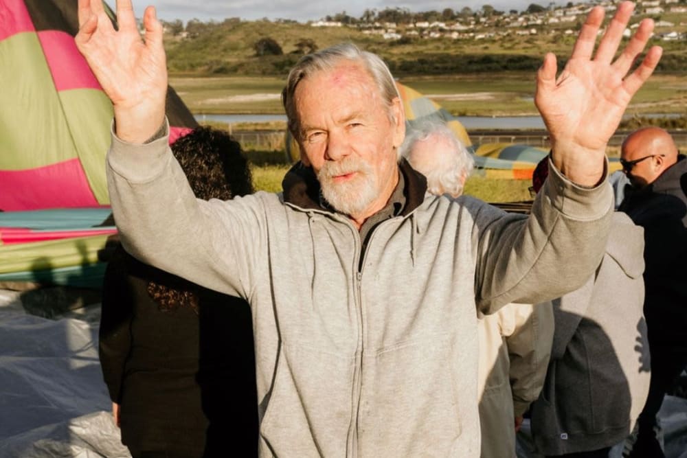 Man waving at Hot Air Balloon Event