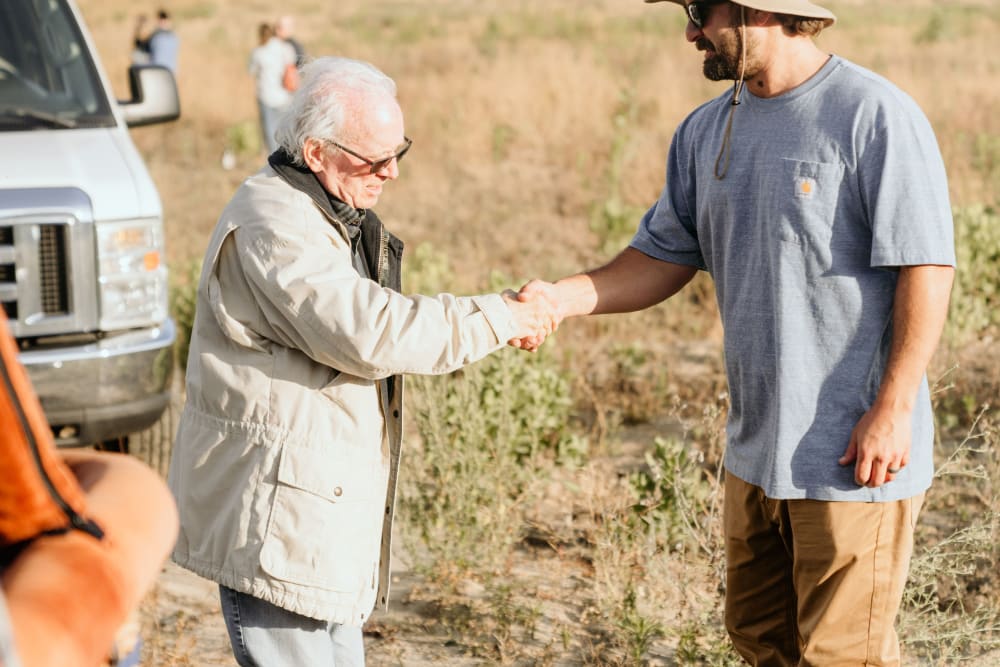 Men shaking hands at Hot Air Balloon Event