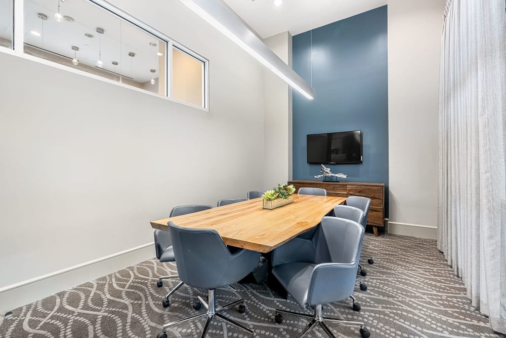 Private meeting room with large table and roller chairs at Marq on Burnet in Austin, Texas