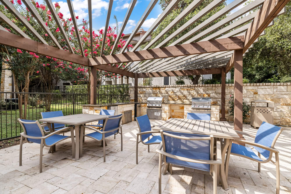 Outdoor grilling stations with tables and chairs at Marquis at Barton Trails in Austin, Texas