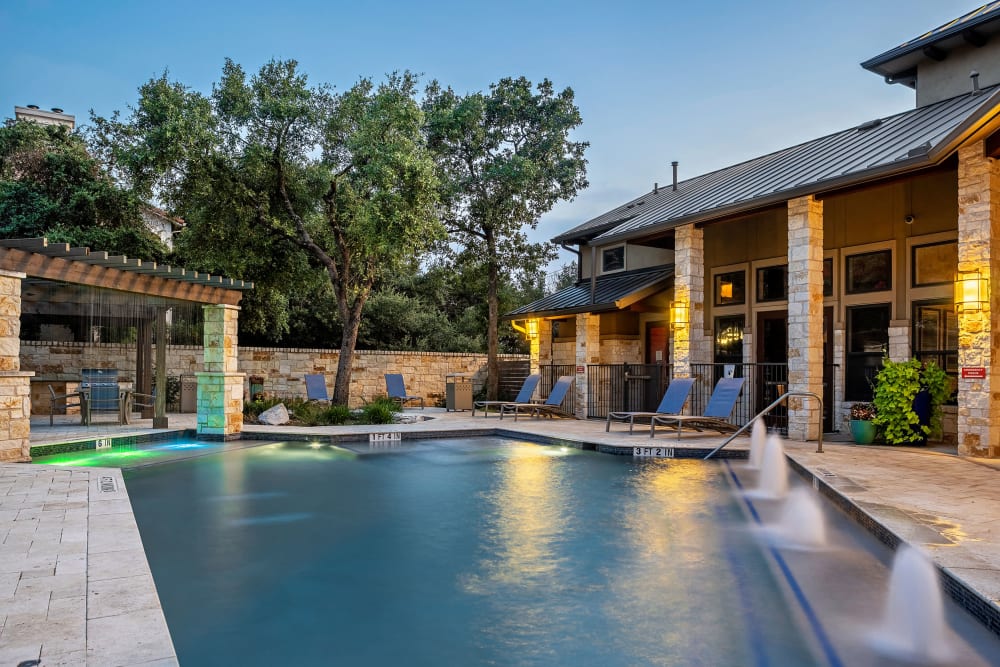 Resort-Style Swimming Pool & Sundeck at twilight at Marquis at Barton Trails in Austin, Texas