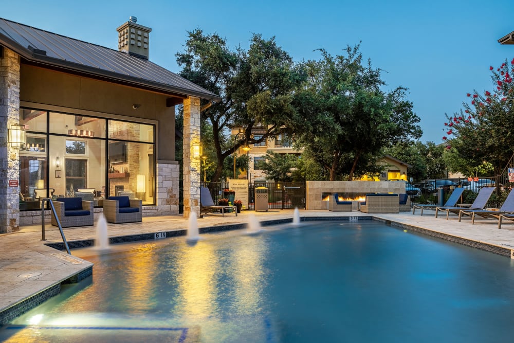 Resort-Style Swimming Pool & Sundeck at twilight at Marquis at Barton Trails in Austin, Texas
