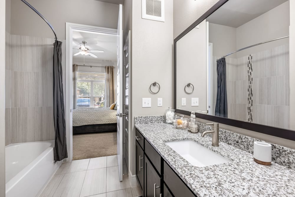 Spacious main bathroom with granite countertops at Marquis at Barton Trails in Austin, Texas