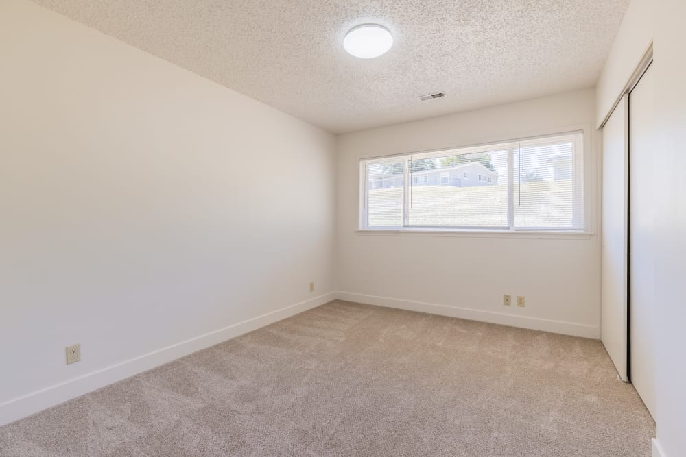 Bedroom with carpet and expansive windows at Davis Hill in Joint Base Lewis McChord, Washington