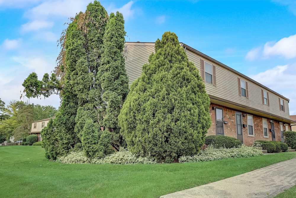 Apartment building with trees all around at North Eden Townhomes in Columbus, Ohio