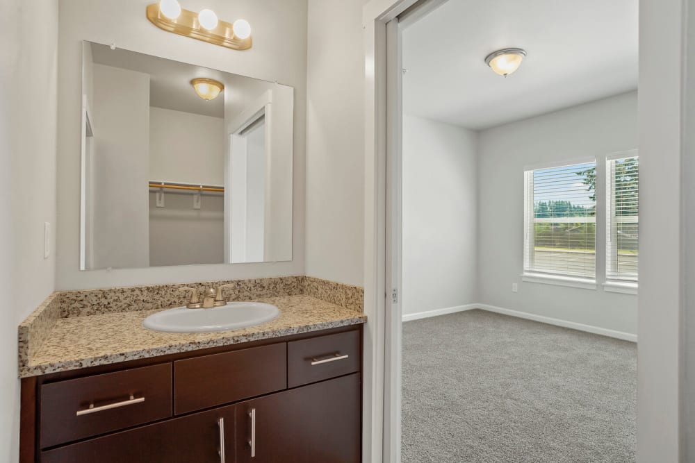 Bedroom adjacent to powder room at Crawford Crossing Apartments in Turner, Oregon