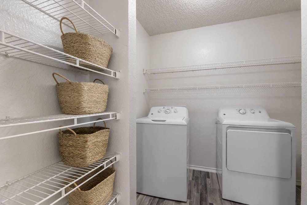 Laundry room with storage at Villas at Chase Oaks in Plano, Texas