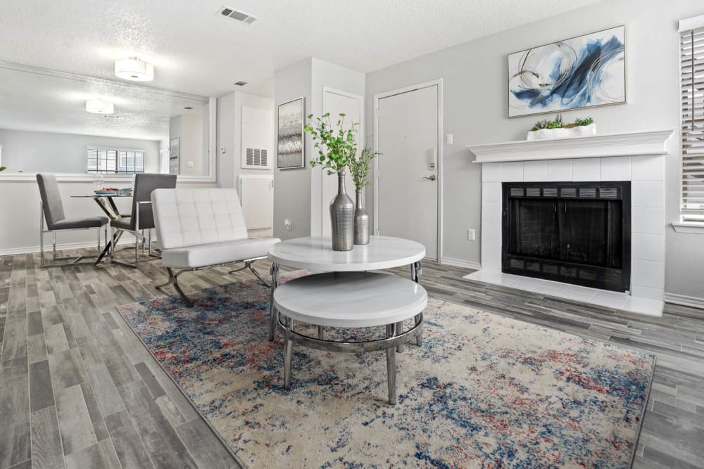 Model living room with an area rug at Fielder's Glen in Arlington, Texas