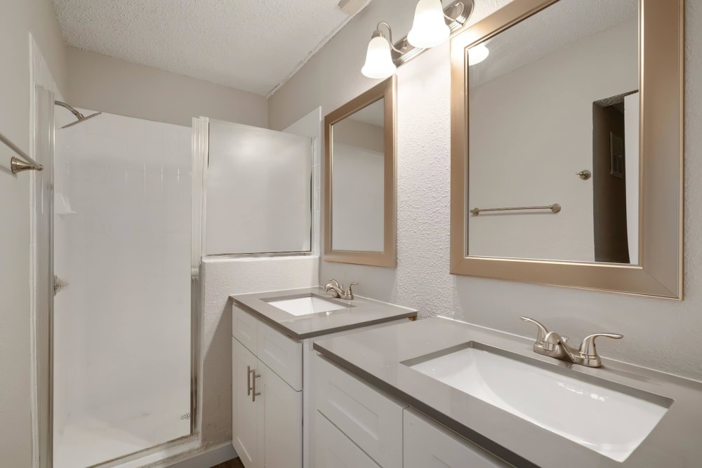 Bathroom with double sinks at Tides at Meadowbrook in Fort Worth, Texas