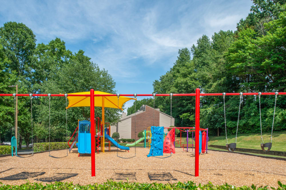 The playground at The Oasis at Regal Oaks in Charlotte, North Carolina featuring its swings