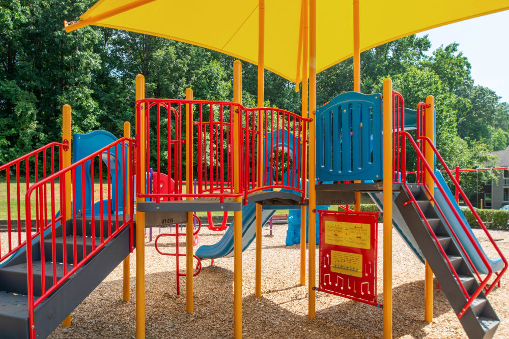 The playground at The Oasis at Regal Oaks in Charlotte, North Carolina featuring its play house