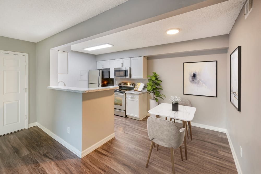 Kitchen with wood-style flooring at Alton Green Apartments in Denver, Colorado