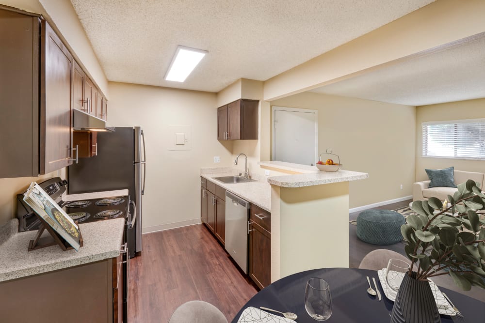 Dining room with wood-style flooring at Alton Green Apartments in Denver, Colorado