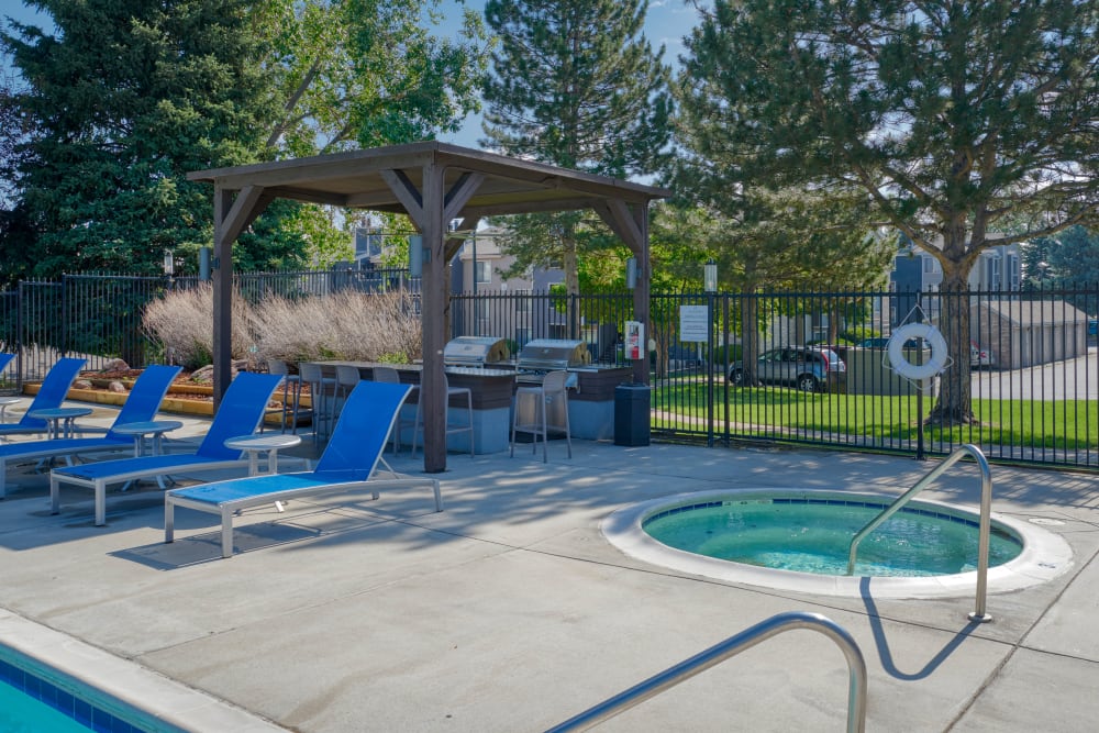 Swimming pool with a sundeck and lounge chairs at Alton Green Apartments in Denver, Colorado