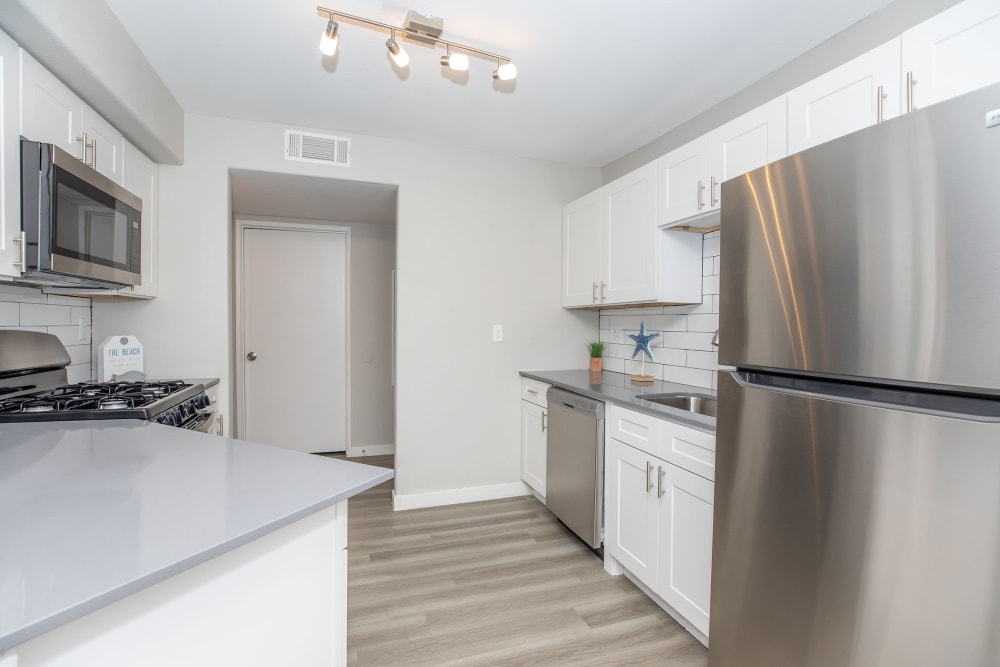 Kitchen with wood-style flooring at Tides at North Nellis in Las Vegas, Nevada