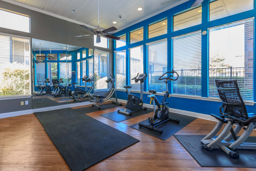 Fitness center with large windows at Tides at Highland Meadows in Dallas, Texas