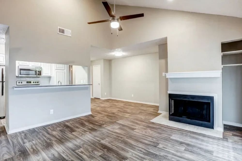 Model living room with hardwood floors at Embry Apartments in Carrollton, Texas