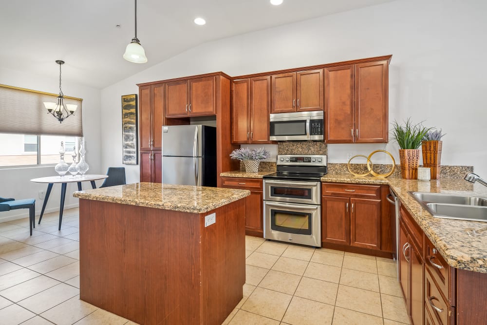 kitchen with cabinets and an island at Ponté Palmero in Cameron Park, California
