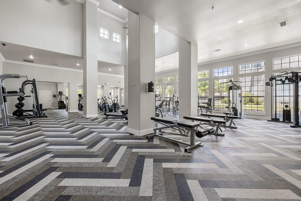 Updated fitness center with cardio and weight machines at Marquis at The Cascades in Tyler, Texas