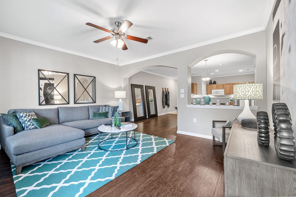 Bright and colorful living area with wood flooring at Marquis at The Cascades in Tyler, Texas