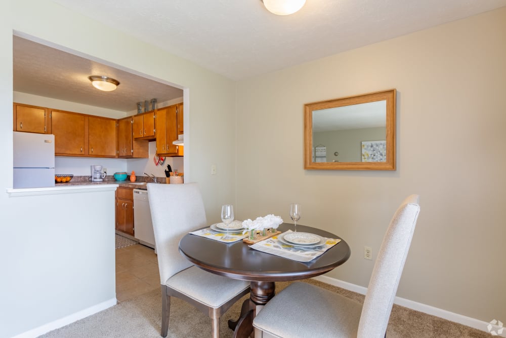 Dining table next to the kitchen in a model home at Columbus Park Apartments in Bedford Heights, Ohio