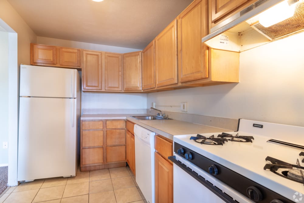 Spacious kitchen with wood-style cabinetry at Columbus Park Apartments in Bedford Heights, Ohio