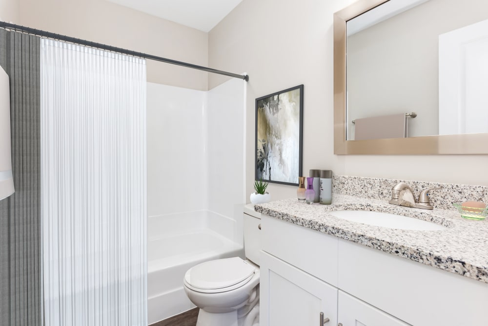 Upgraded bathroom with framed mirror and granite counter on vanity  The Hills at Oakwood Apartment Homes in Chattanooga, Tennessee