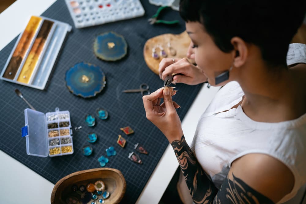 Woman making earrings in her apartment at 1510 Belleville in Richmond, Virginia