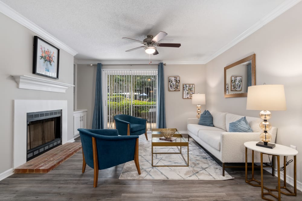 A furnished living room with a fireplace at Regency Gates in Mobile, Alabama