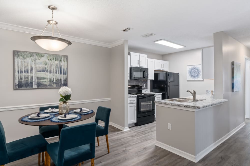 An apartment dining room and kitchen at Regency Gates in Mobile, Alabama