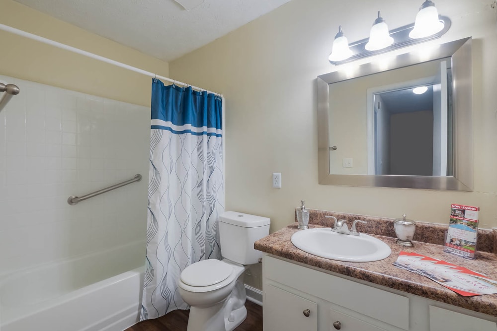 Bathroom with hardwood flooring at The Grove at Six Hundred Apartment Homes in Rome, Georgia