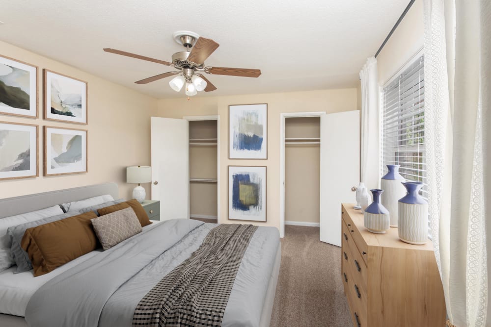 Bedroom with ceiling fan at The Grove at Six Hundred Apartment Homes in Rome, Georgia