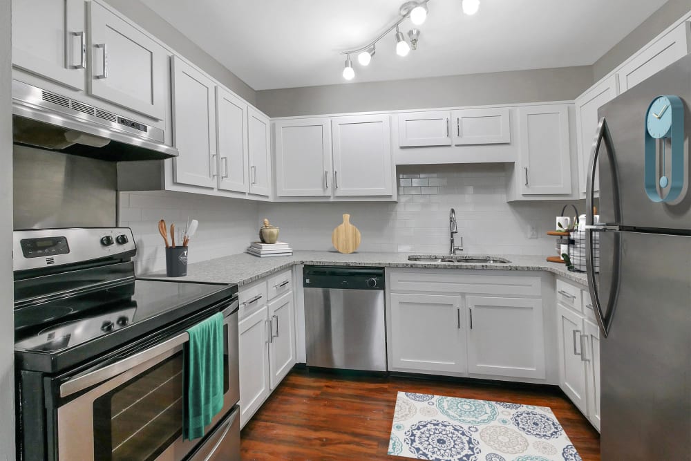 Kitchen with beautiful hardwood flooring at The Grand Apartments in Chattanooga, Tennessee