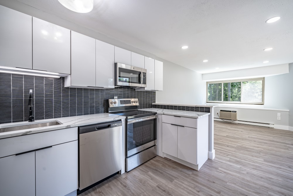 A modern kitchen with stainless steel appliances at Whitewood Pond Apartments in North Haven, Connecticut