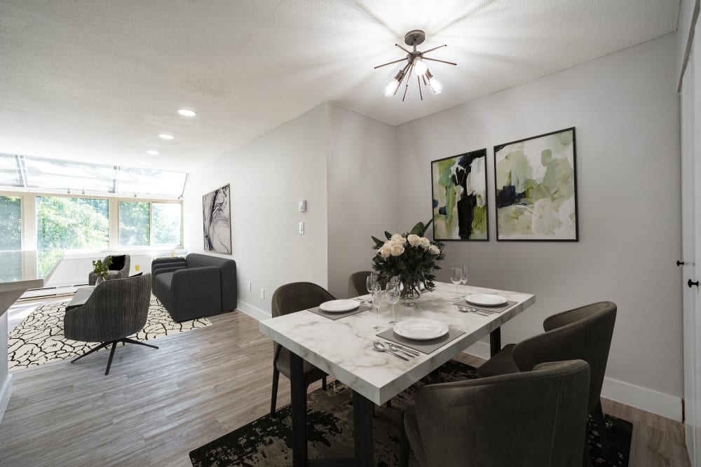 A set dining room table and a furnished living room beyond at Whitewood Pond Apartments in North Haven, Connecticut