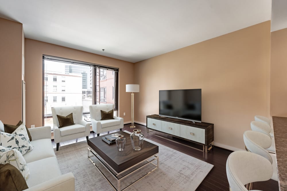 A furnished living room with a sliding door to the balcony at Front Street Lofts in Hartford, Connecticut