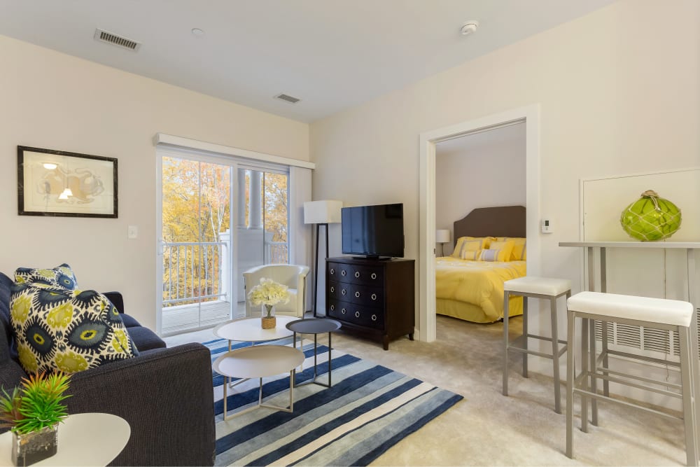 A furnished model apartment living room and bedroom at Sound at Gateway Commons in East Lyme, Connecticut
