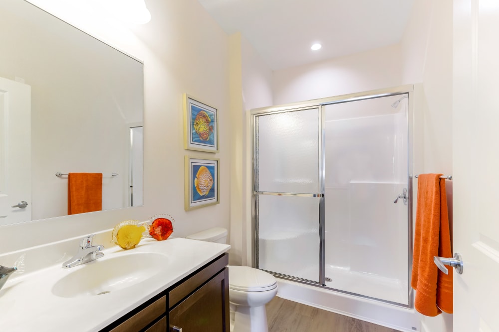 Sliding doors on a bathtub in an apartment bathroom at Sound at Gateway Commons in East Lyme, Connecticut