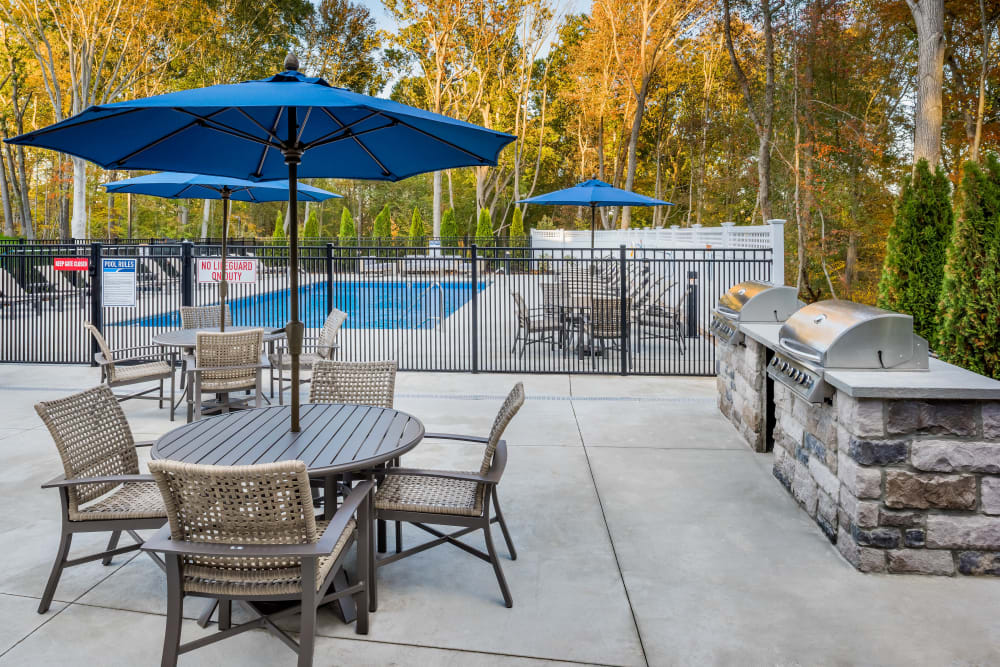 Patio seating beside the gated community swimming pool at Cove at Gateway Commons in East Lyme, Connecticut