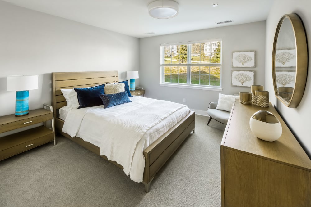 A spacious main bedroom in a model apartment at Cove at Gateway Commons in East Lyme, Connecticut