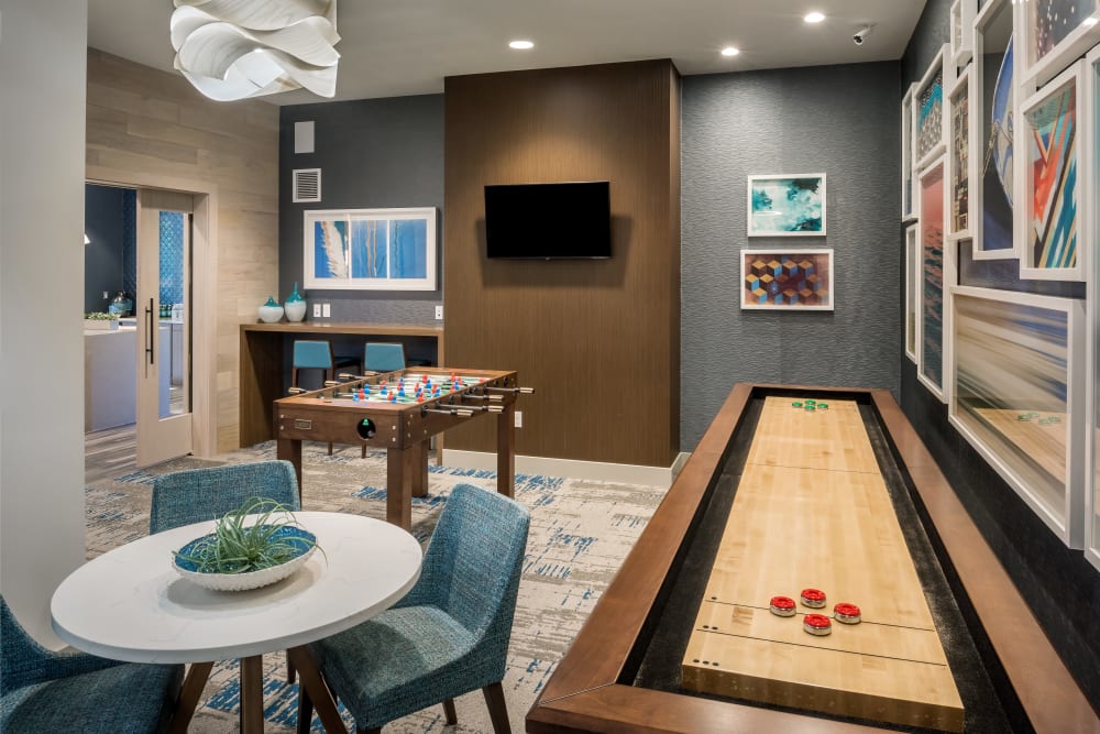 A shuffle board table in the community clubhouse at Cove at Gateway Commons in East Lyme, Connecticut