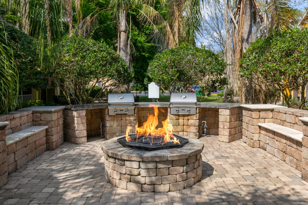 Fire pit and BBQ grilling area at Citrus Tower | Apartments in Clermont, Florida
