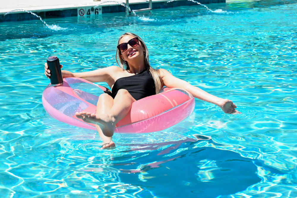 A resident on a floatie in the pool at The Flats at East Bay in Fairhope, Alabama