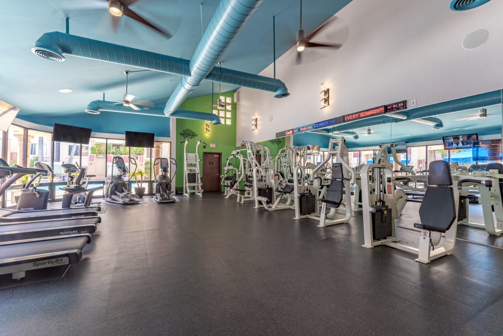 Large fitness center with various weight training and aerobic exercise equipment at Veranda La Jolla in San Diego, California