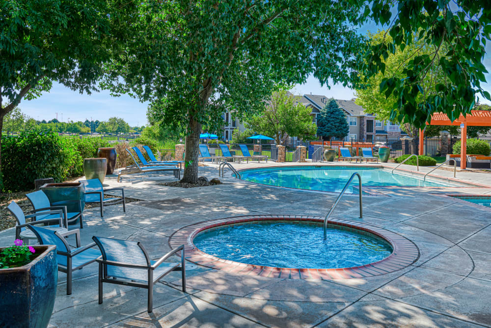 Beautiful resort-style swimming pool with lounge chairs at Gateway Park Apartments in Denver, Colorado