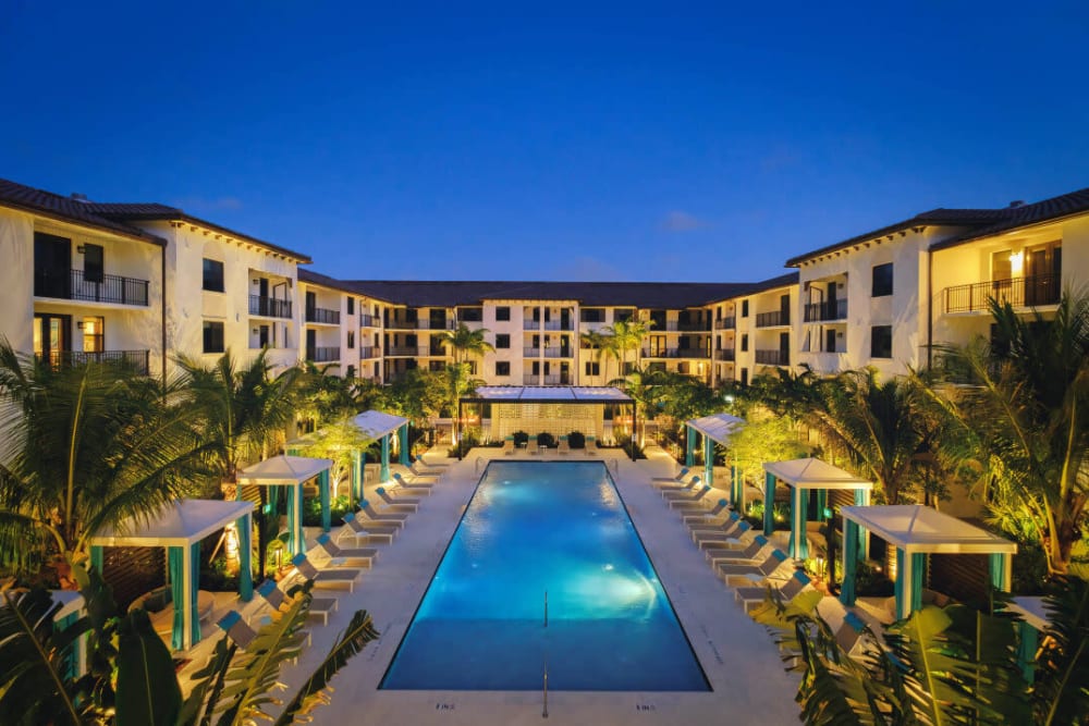 Night time view of community swimming pool at The Residences at Monterra Commons in Cooper City, Florida
