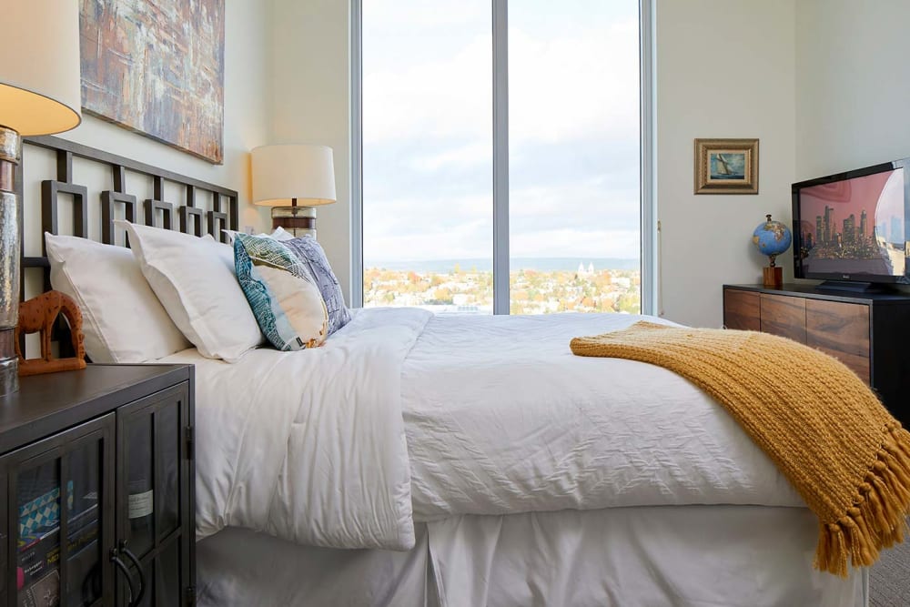 Bedroom in unit with yellow blanket at Murano in Seattle, Washington