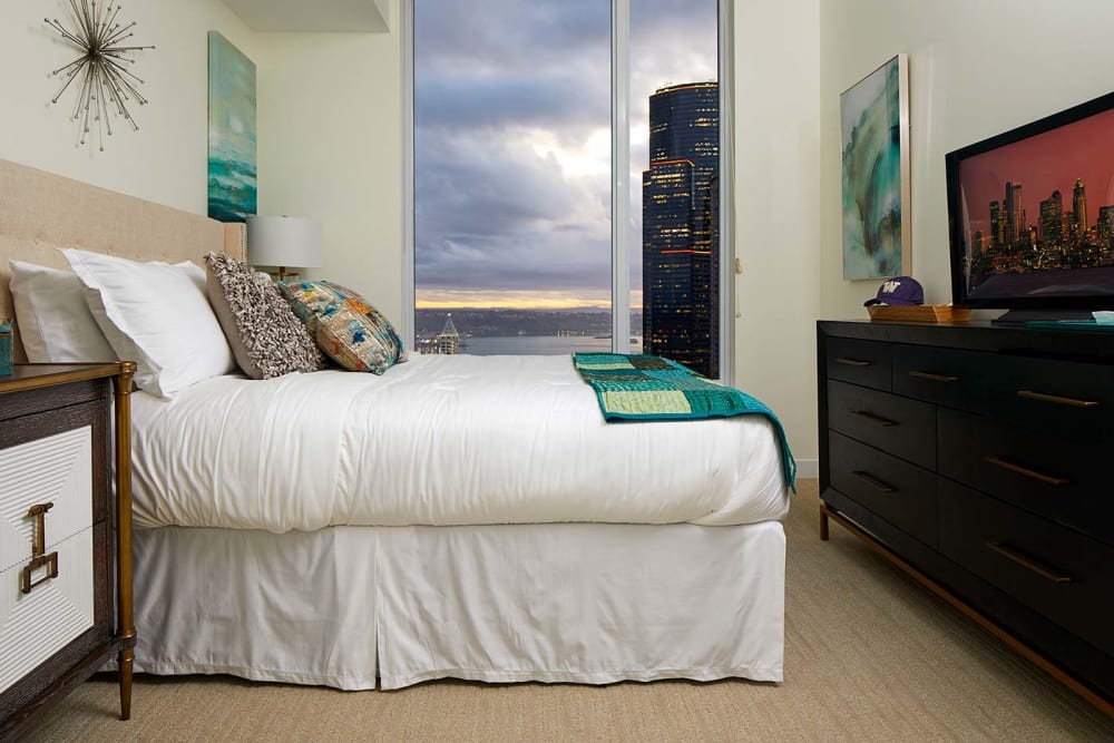 Bedroom with blue and green blanket at Murano in Seattle, Washington