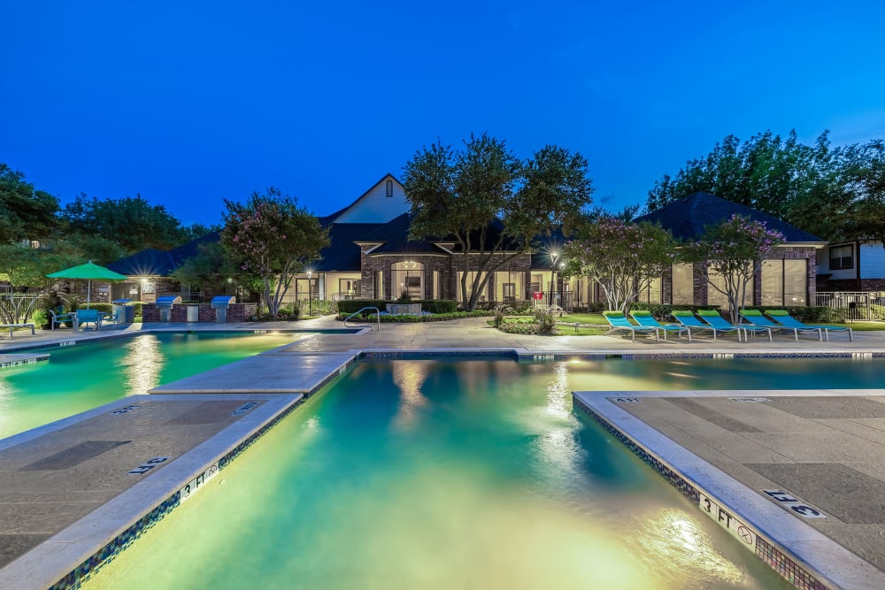 Resort-style Swimming pool at twilight at Marquis at Stonebriar in Frisco, Texas