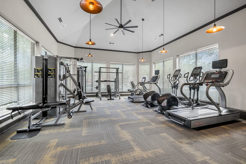 Fitness center with cardio and weight training equipment at Marquis at Stonebriar in Frisco, Texas